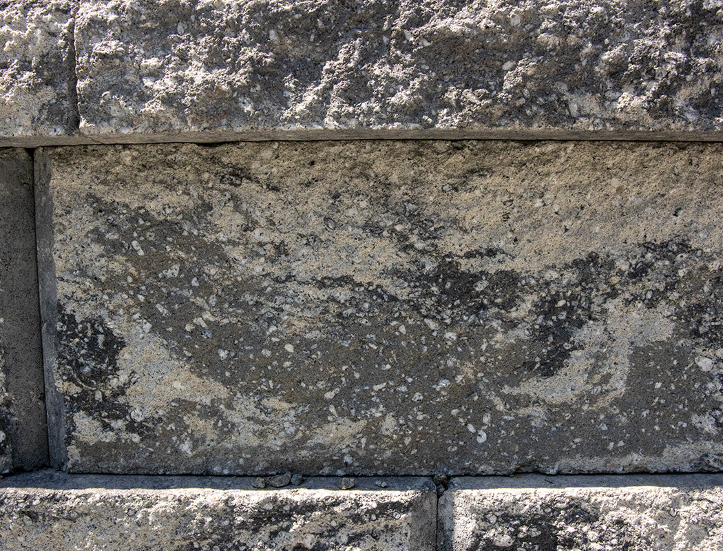 Close-up of a stone wall with visible texture and color variations.