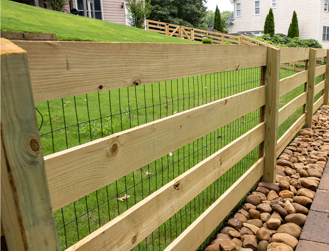 Wooden fence with wire mesh on a grassy area