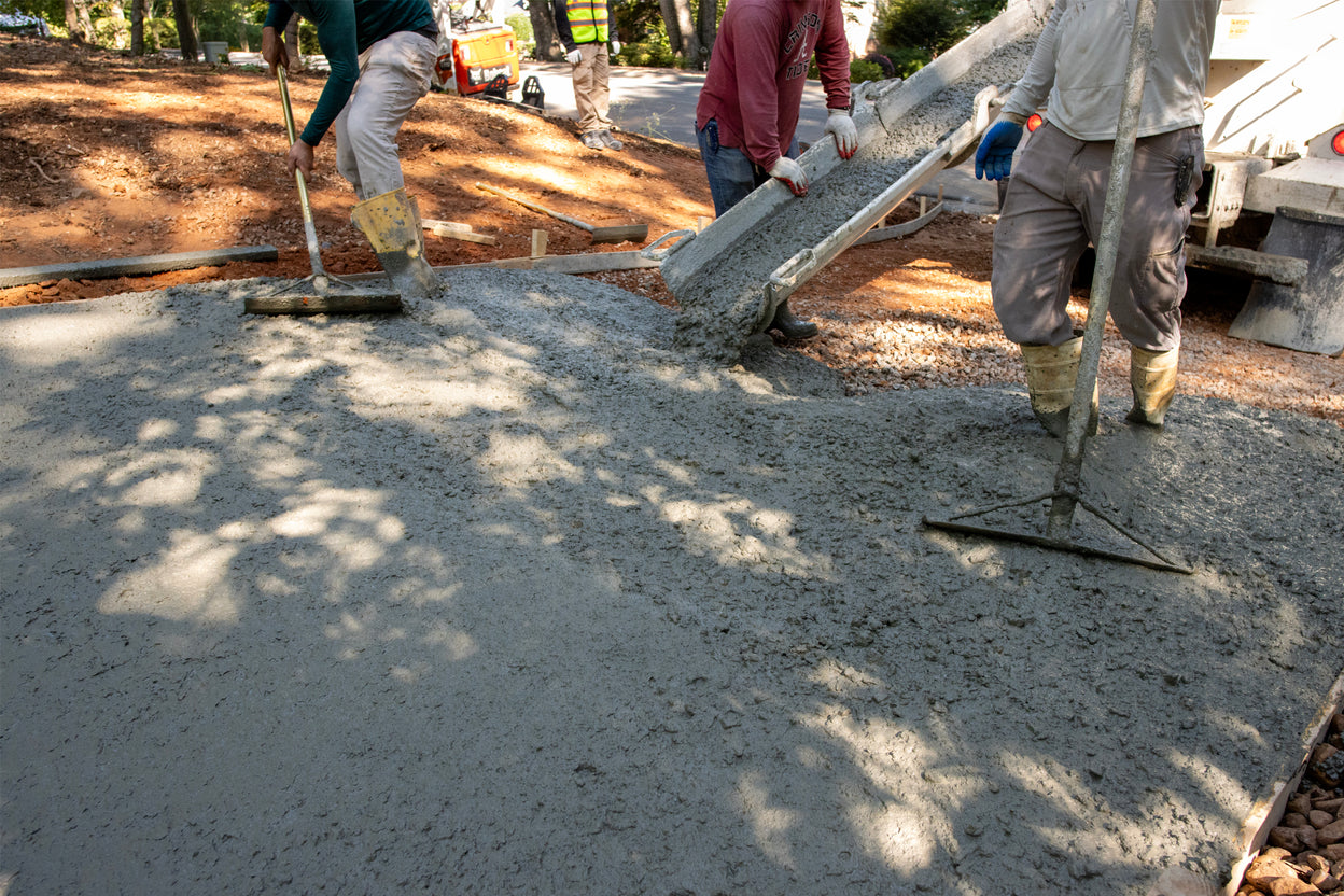 Workers leveling concrete on a construction site