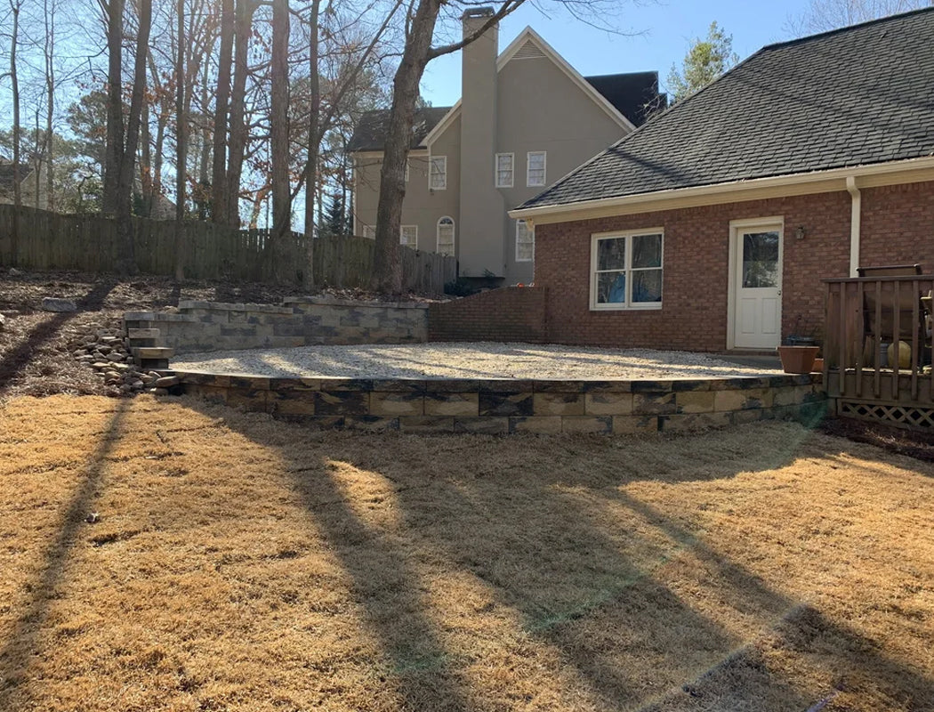 Backyard with a foundation for a new structure and drainage control